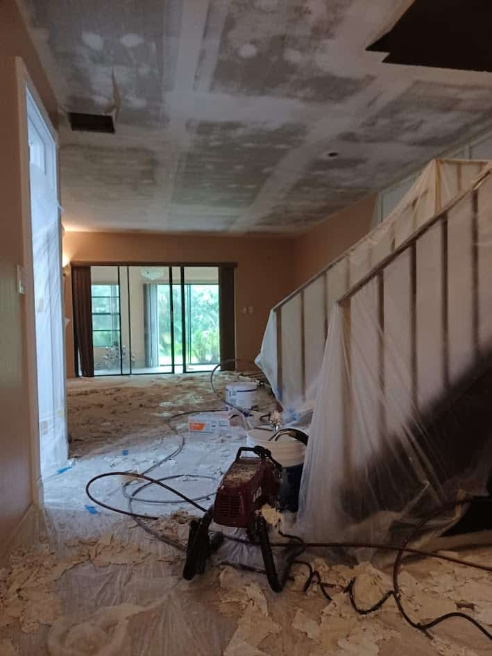During professional popcorn ceiling removal in living area